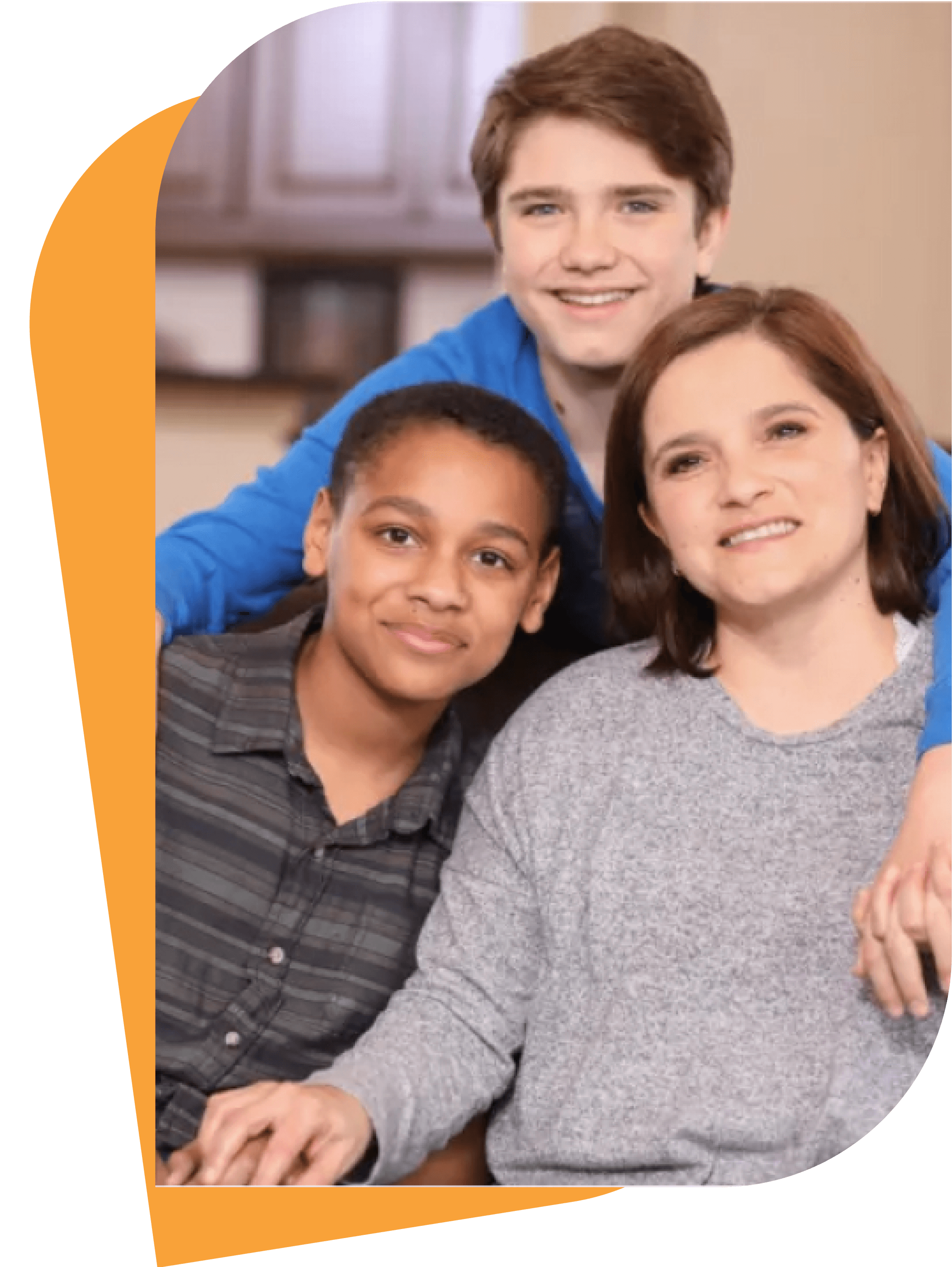 Smiling mother sitting with her two sons, one with his arm around her shoulders.